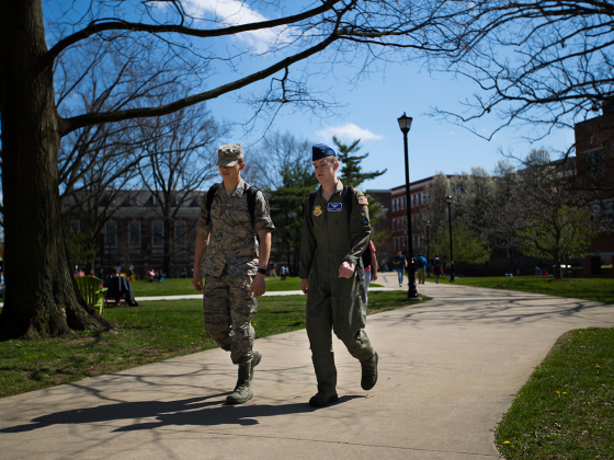 Two students in military uniforms walking to class.