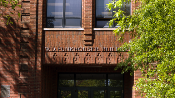 The front doors of the W.D. Funkhouser building framed by trees.