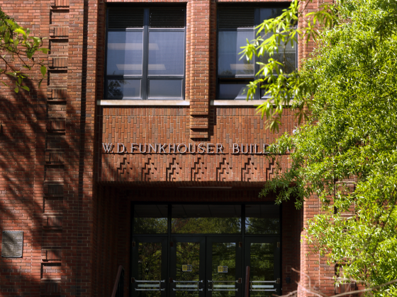 The front doors of the W.D. Funkhouser building framed by trees.