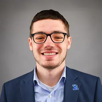 A headshot of Aaron Benjamin